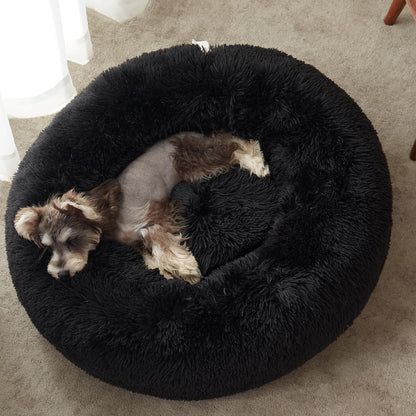 Black faux fur calming donut bed - puppy curled up inside